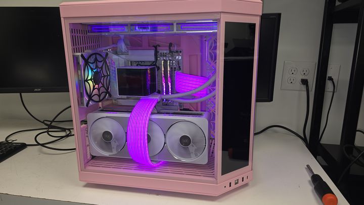 Pink and white custom PC with purple lighting and illuminated cables